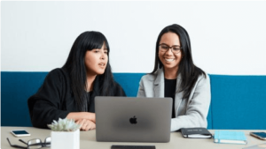 Two people working together with a laptop